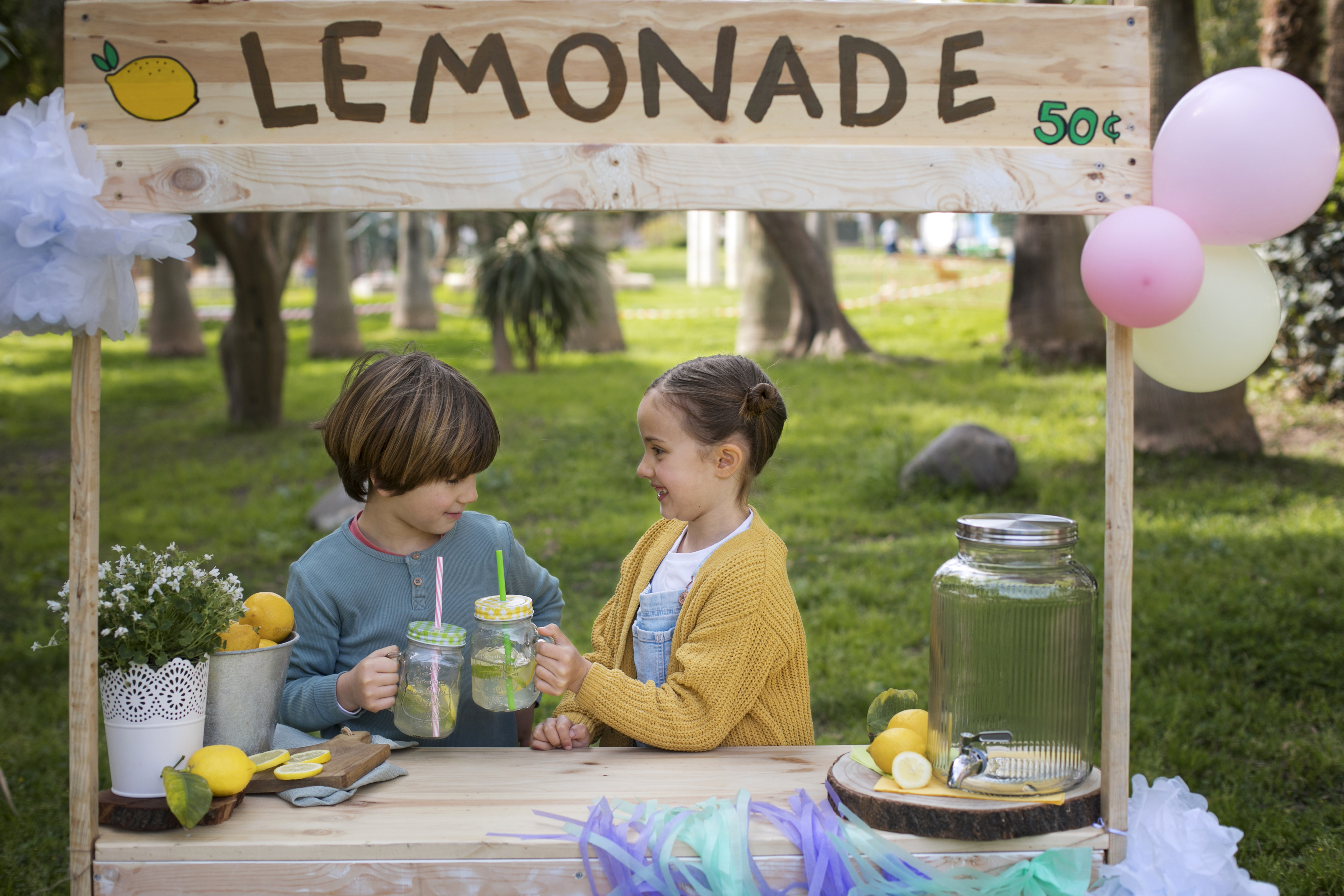 Kids' lemonade stand setup (lemonade dispenser and stand sign)